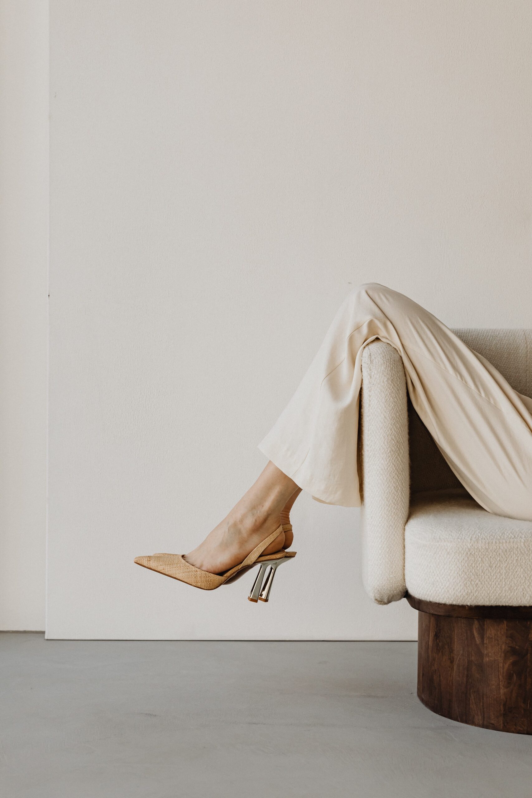 brand photography of woman in high heels sitting in a chair